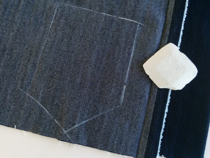 A pocket is marked on the bad side of a piece of double-folded denim, ready to
be cut good sides together. After cutting both layers, this will yield two
pockets that are mirror images of each other A pocket is marked on the bad side of a piece of double-folded denim, ready
to be cut good sides together. After cutting both layers, this will yield two
pockets that are mirror images of each other.